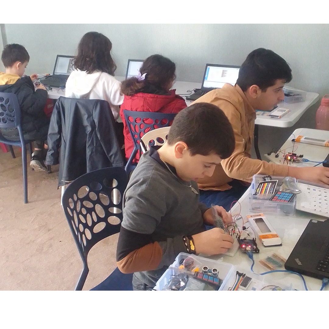 Students building electronics projects in a classroom