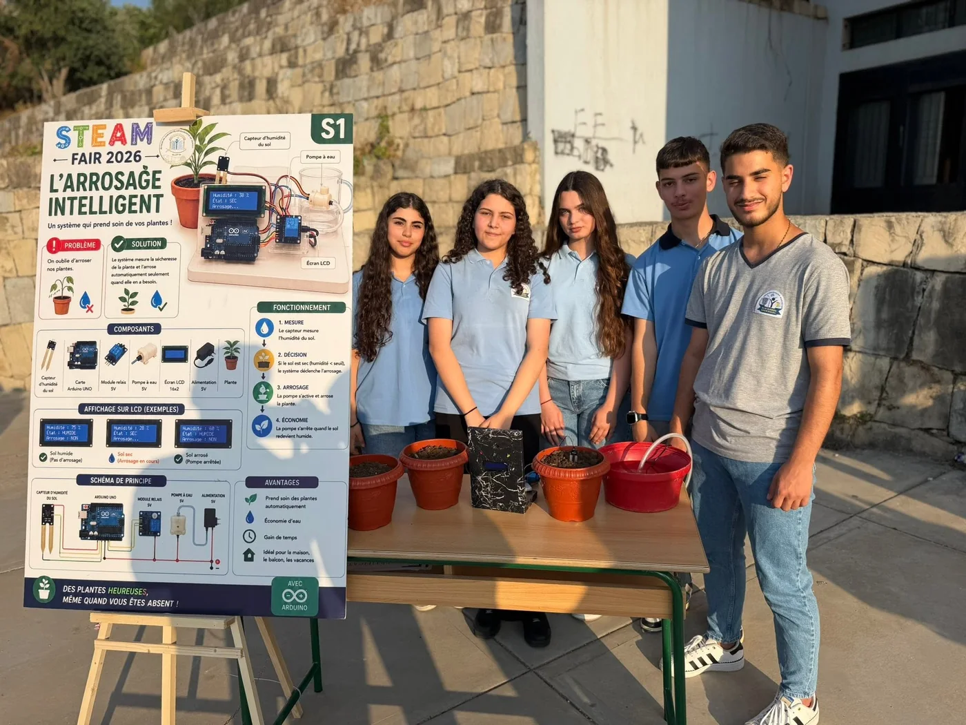 Students presenting an intelligent irrigation project at a STEAM fair